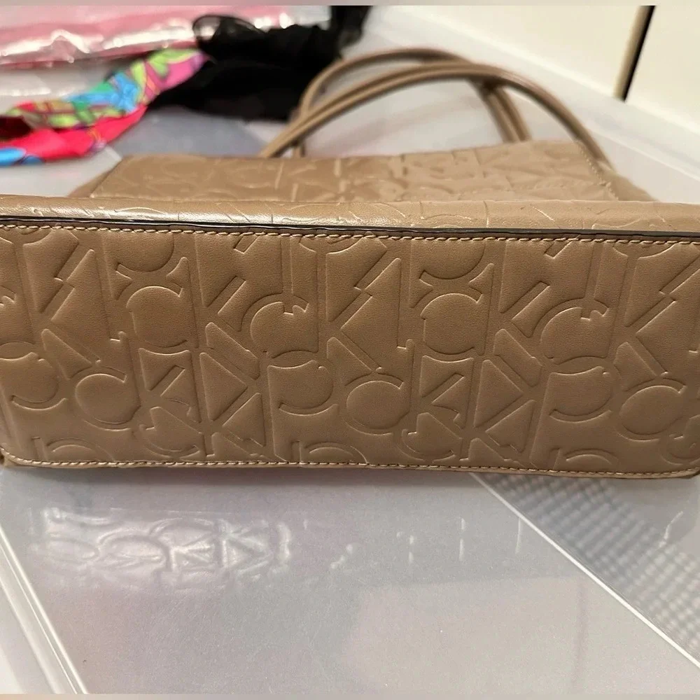 Calvin Klein logo purse. Leather and chain strap. Taupe color, 3 compartments